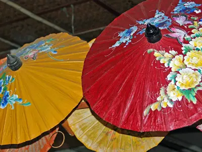Yellow, orange and red painted paper umbrellas displayed at an umbrella workshop near Chiang Mai