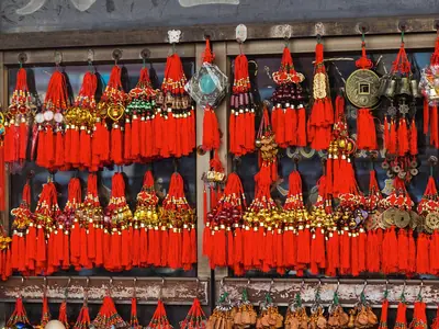 Rows of red tassels and ornaments for sale for Chinese New Year at Yaowarat in Bangkok (2016)