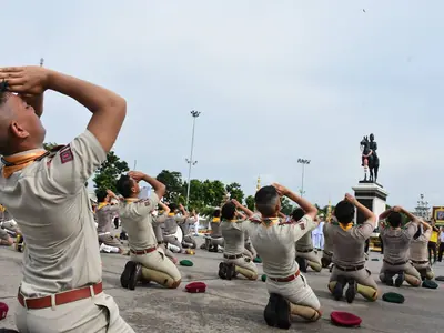 Scouts in uniform bow in homage before the equestrian statue of King Chulalongkorn on Chulalongkorn Day