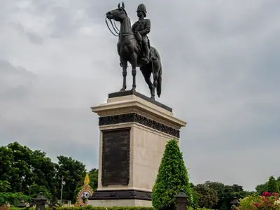 The equestrian statue of King Chulalongkorn (Rama V) at Dusit Palace, Bangkok, with yellow flowers in the foreground