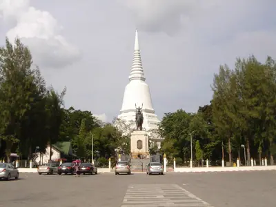 White chedi of the Don Chedi memorial seen along a quiet road