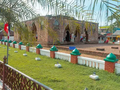 Krue Se Mosque in Pattani with a lawn and railing in the foreground