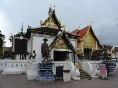 The Chiang Mai City Pillar shrine (Inthakin) at Wat Chedi Luang with a statue in front