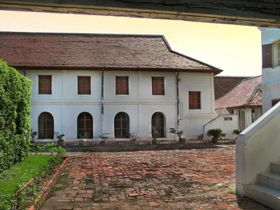 White colonial-style palace building and brick courtyard at Narai Ratchaniwet in Lopburi