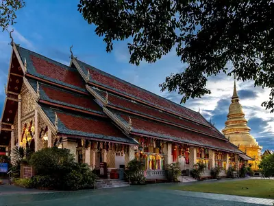 Red-roofed viharn and golden chedi of Wat Phra That Hariphunchai in Lamphun