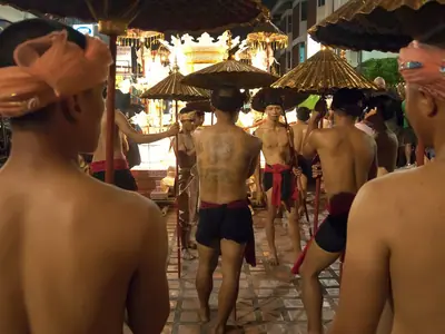 Shirtless men carrying a float in the Loy Krathong parade in Chiang Mai
