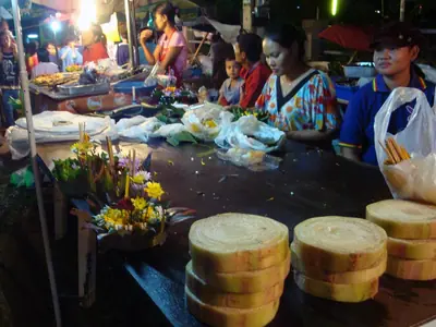 Krathong bases made of banana trunk slices stacked on a night-market stall (2008)