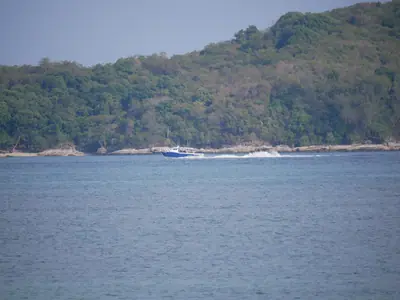 Calm water and wooded hills at Rawai Beach, Phuket