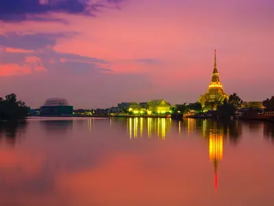Wat Sothon Wararam Woraviharn mirrored in the water at sunset in Chachoengsao
