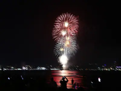 Red and white fireworks reflected on the water at Pattaya (28 November 2020)