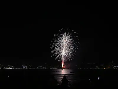 A white firework burst over the sea at Pattaya at night (28 November 2020)