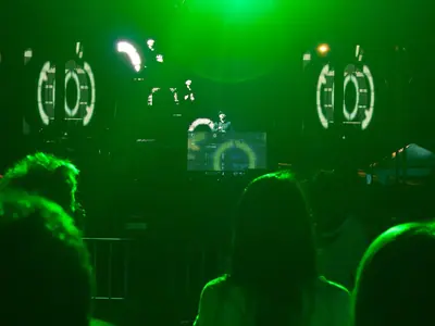The crowd in a green-lit club at the Pattaya Music Festival