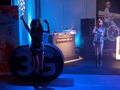 Dancers and DJ booth lit in blue at the Pattaya Music Festival
