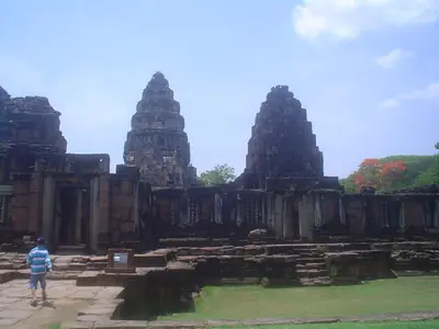Prangs of Phimai Historical Park seen across the stone courtyard