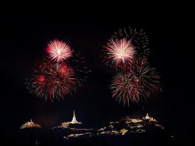 Red and white fireworks over Phra Nakhon Khiri hill in Phetchaburi at night