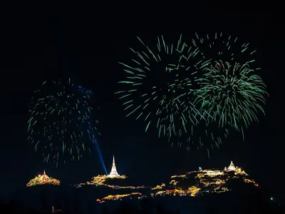 Green fireworks above the illuminated Phra Nakhon Khiri hilltop palace complex