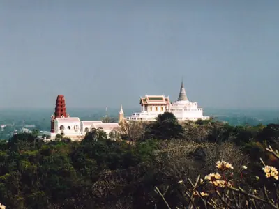 The white palace buildings and red chedi on top of Khao Wang hill in Phetchaburi