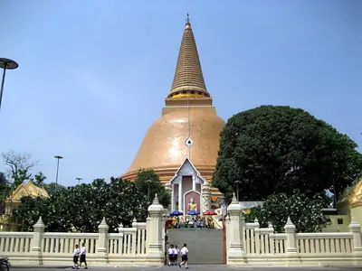 Phra Pathom Chedi seen across a white balustrade and trees