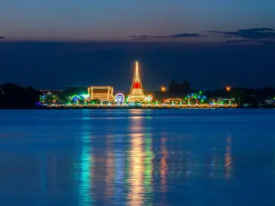 Phra Samut Chedi lit up at night across the Chao Phraya River in Samut Prakan