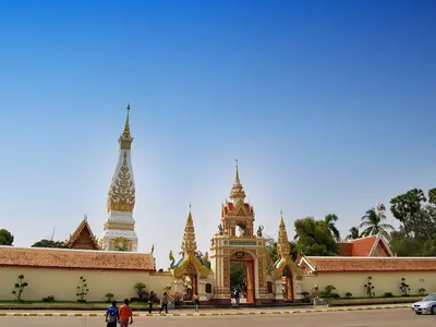 Wat Phra That Phanom with its gate and chedi under a blue sky