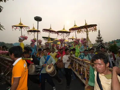 Musicians and participants with parasols in the Poi Sang Long procession