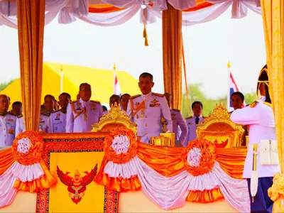 Officials on a stage decorated in orange and white during the Royal Ploughing Ceremony