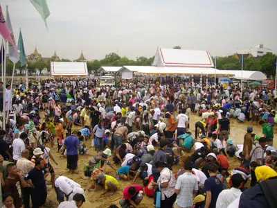 People crowd the field searching for blessed rice grains after the Royal Ploughing Ceremony (2009)