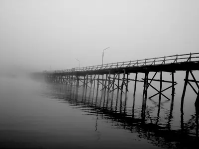 The Mon Bridge in Sangkhlaburi fading into mist