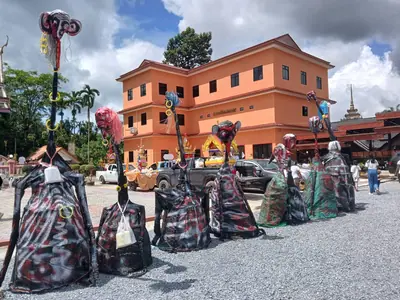 Costumed figures gathered in front of a building at Wat Thung Luang in Surat Thani during Sat Duan Sip (2 October 2024)