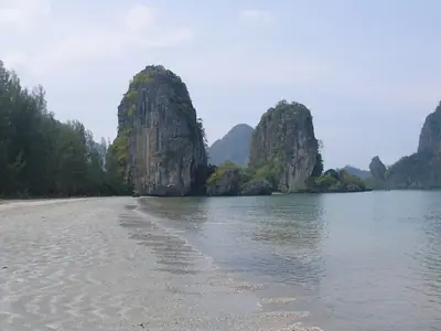 Limestone karst towers rising from calm water in Rajamangala Bay, Trang