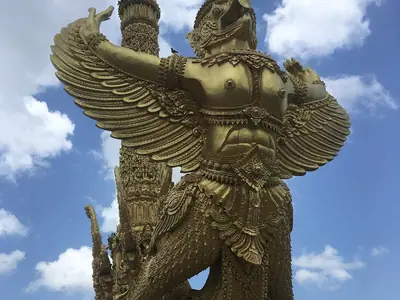Golden garuda wax sculpture with outspread wings in Thung Si Muang park, Ubon Ratchathani