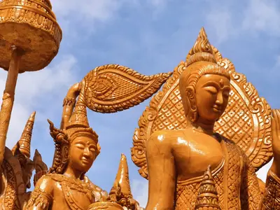Close-up of golden carved wax figures on a float at Wat Phasukaram during the Ubon Ratchathani Candle Festival (July 2026)