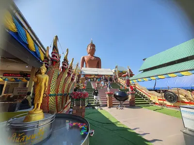 Naga balustrade and colourful decoration near the Luang Phor Somwang statue at Wat Bang Phra