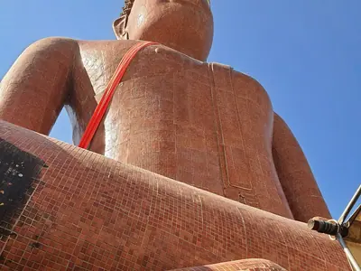 Lower part of the large Luang Phor Somwang statue at Wat Bang Phra seen from below