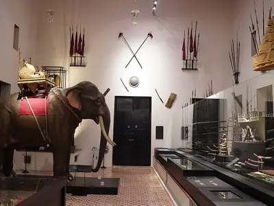 Siamese war elephant and antique weaponry (swords, polearms, shields and muskets).