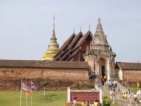 Chedi and old hall behind the temple wall, Wat Phra That Lampang Luang