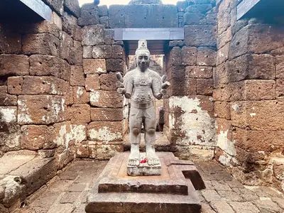 Statue inside a laterite gallery, Prasat Mueang Sing