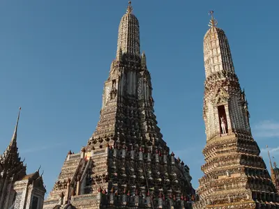 Two prangs seen from below against a blue sky, Wat Arun