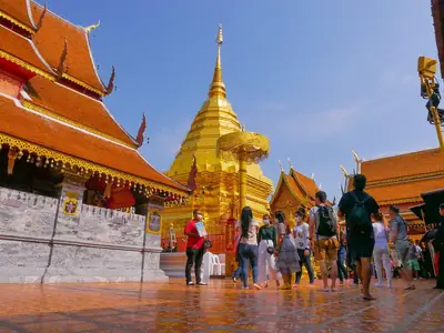Visitors walking around the golden chedi, Wat Phra That Doi Suthep