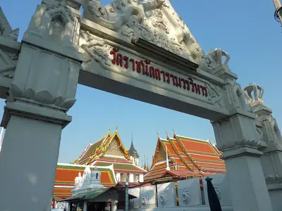 Temple gate with ornate roofs behind, Wat Ratchanatdaram