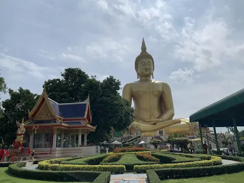 Giant seated Buddha in the temple gardens, Wat Muang