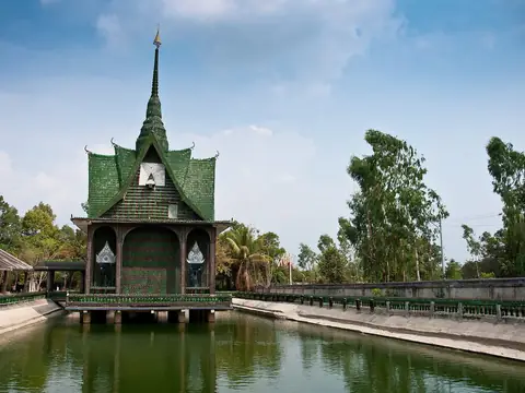 Hall decorated with glass bottles beside a pond, Wat Pa Maha Chedi Kaew