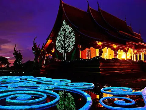 Glowing tree mural at night, Wat Sirindhorn Wararam Phu Prao