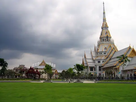 White ordination hall with tall spire, Wat Sothonwararam