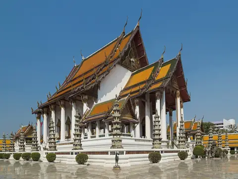 Main hall with white columns and tiered roofs, Wat Suthat and the Giant Swing